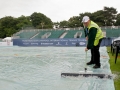 LIVERPOOL, ENGLAND - Wednesday, June 17, 2009: Groundsman Will Tomlinson clears water from the rain covers covering centre court as rain delays the start on Day One of the Tradition ICAP Liverpool International Tennis Tournament 2009 at Calderstones Park. (Pic by David Rawcliffe/Propaganda)